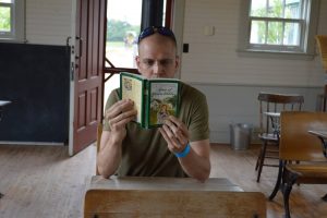 Adam reading Anne of Green Gables in a Schoolhouse in Avonlea