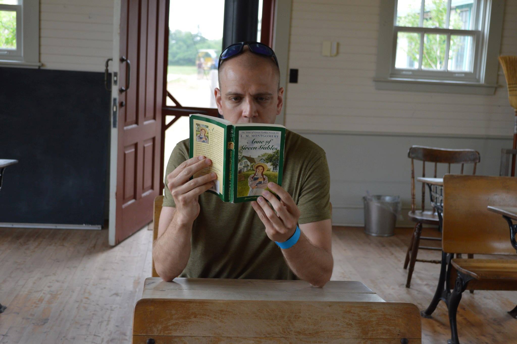 Adam reading Anne of Green Gables in a Schoolhouse in Avonlea